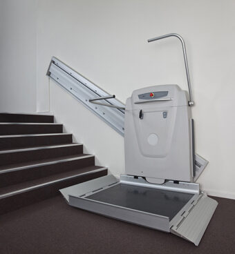 Access BDD IPL Supra Linea inclined platform lift installed alongside an indoor staircase, providing safe and reliable wheelchair accessibility between building levels.