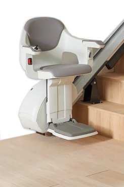A motorized stair lift from Windy City Stairlifts - Homepage, featuring a padded seat and armrests, is installed beside a wooden staircase to help people with mobility issues move up and down the stairs safely.