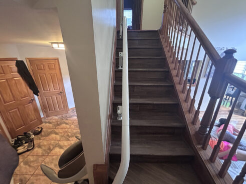 A Flow X curved stairlift by Access BDD installed in Hanover Park, IL on a curved staircase.